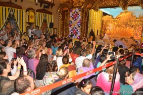 People watching flower abhishek for the dieties - Radhanath Swami