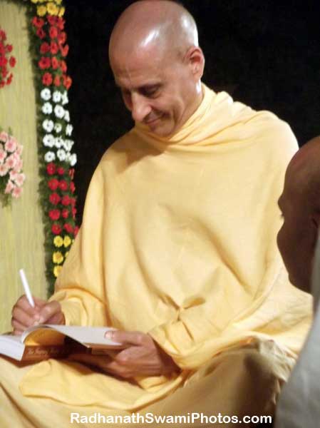Radhanath Swami Signing his Book