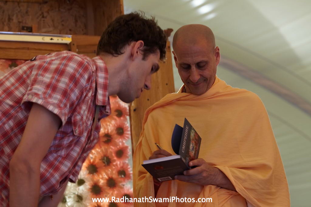 Radhanath Swami Signing his Book