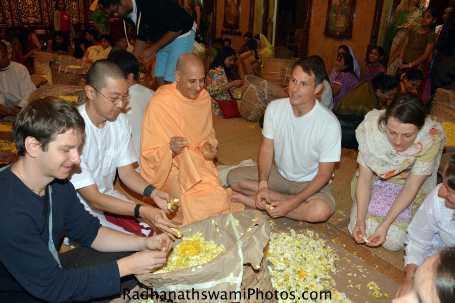 Radhanath Swami plucking flowers for lord-