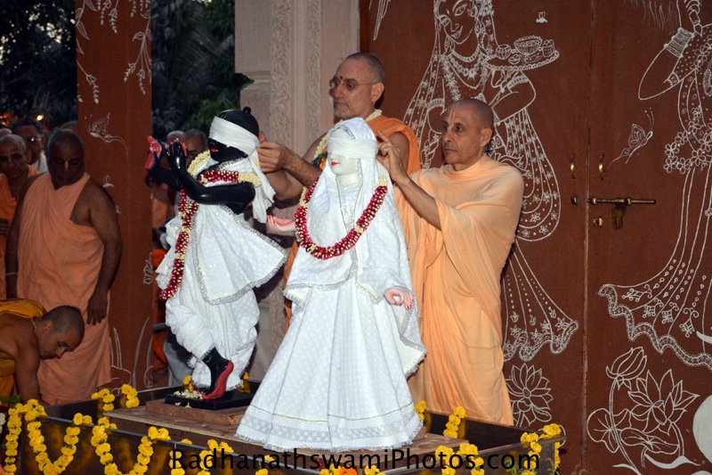 Radhanath Swami and Bhakti vidyapurna Swami opening the eyeband of Deities