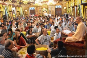 Radhanath Swami speaking during people plucking flower petals for the festival