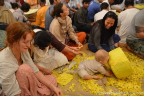 A child playing while plucking flowers - Radhanath Swami