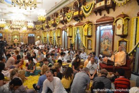 Radhanath Swami speaking during people plucking flower petals for the festival