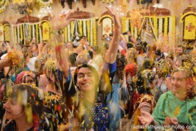 Yoga people throwing flower petals among each other - Radhanath Swami