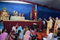 Radhanath Swami offering lamp to Lord Damodara