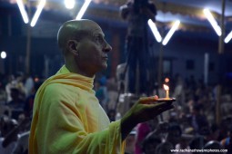 Radhanath Swami offering lamp to Lord Damodara