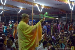 Radhanath Swami offering lamp to Lord Damodara